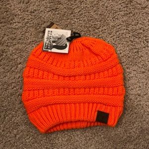 Women’s orange beanie tail